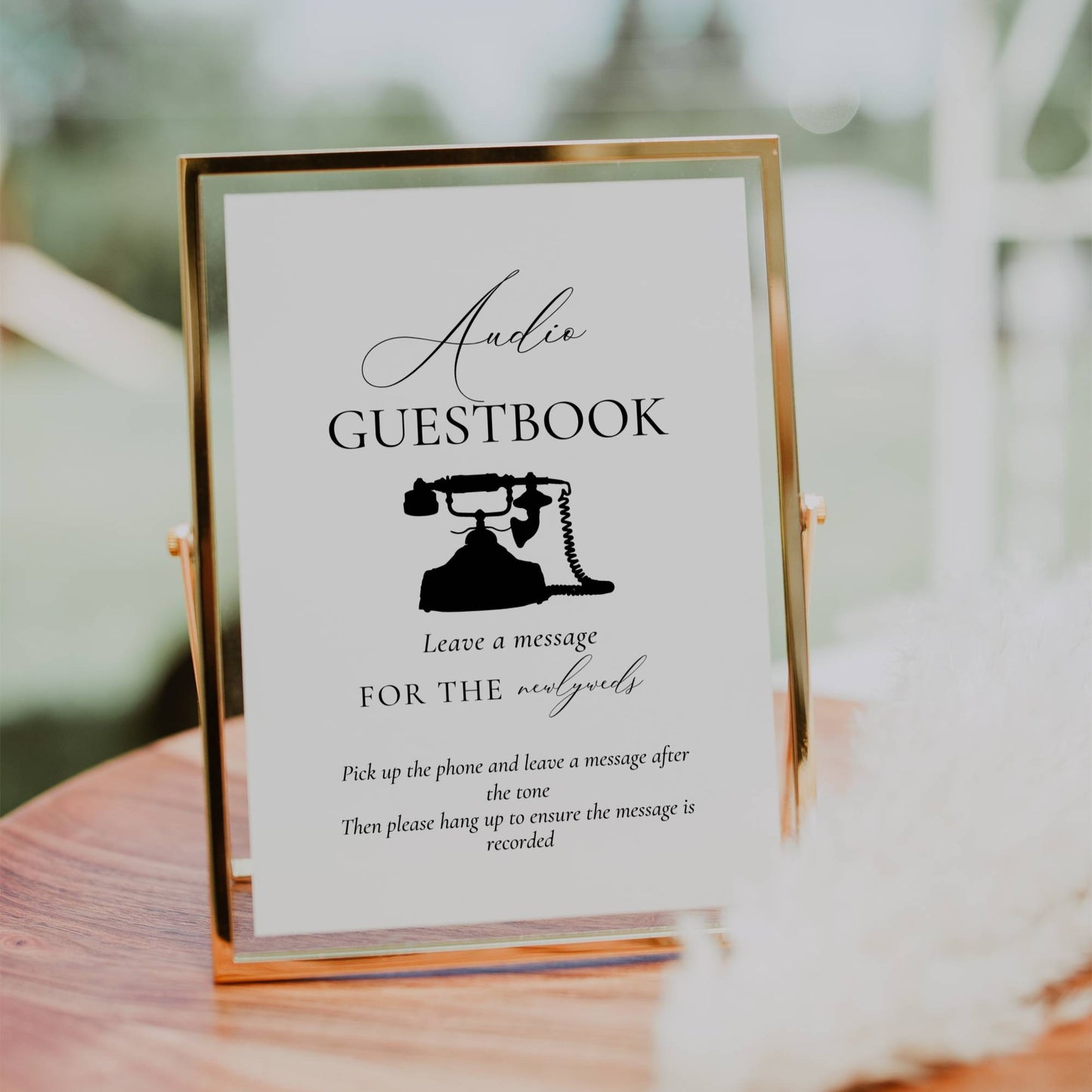 Guestbook sign with a vintage phone illustration on a wooden surface outdoors.