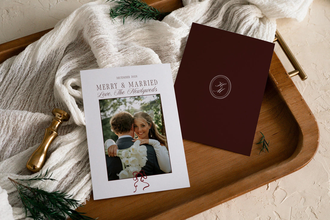 Merry and Married newlywed Christmas card template shown front and back on a wooden tray, with a wedding photo and a burgundy monogram back