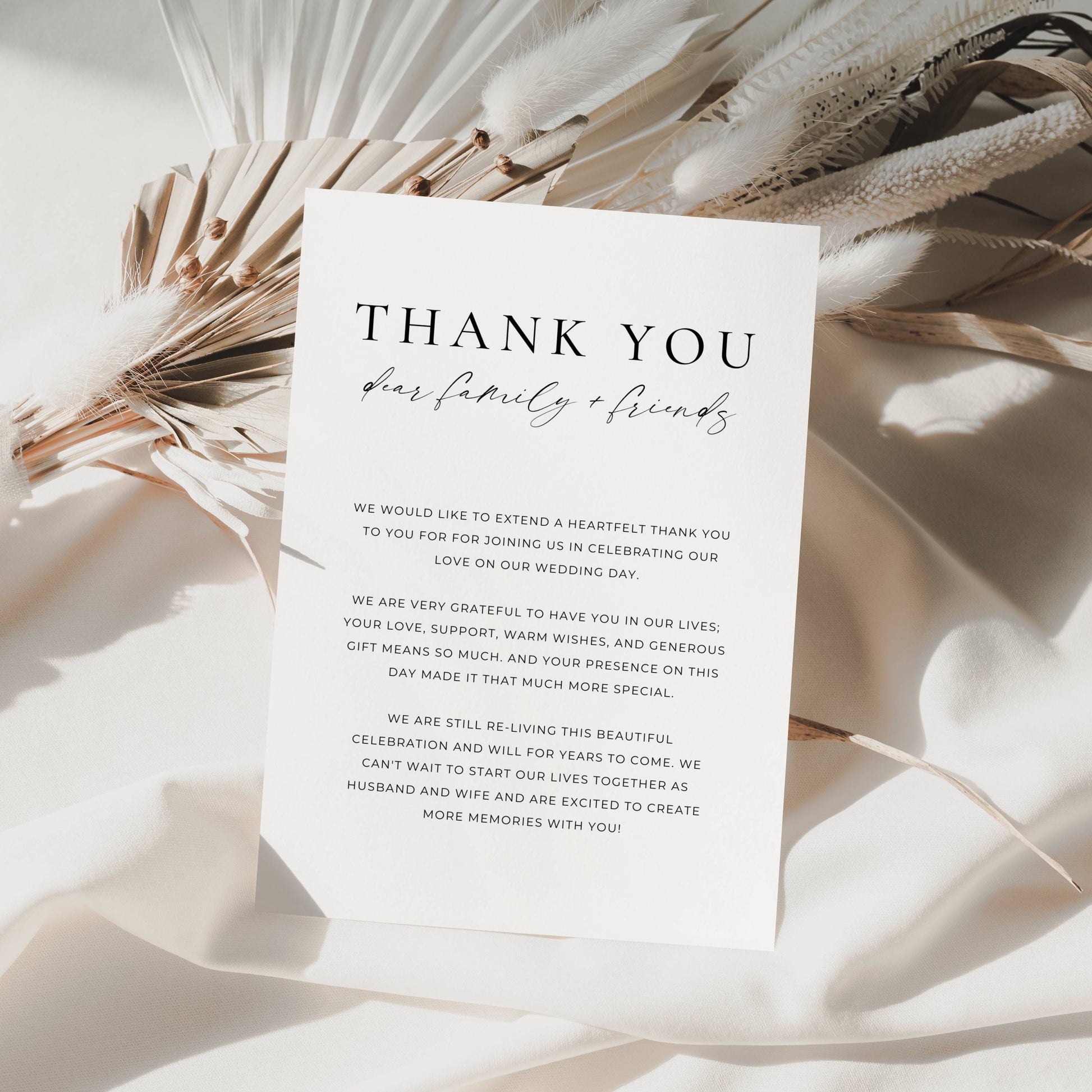 White card with 'Thank You' message on a light background with dried plants