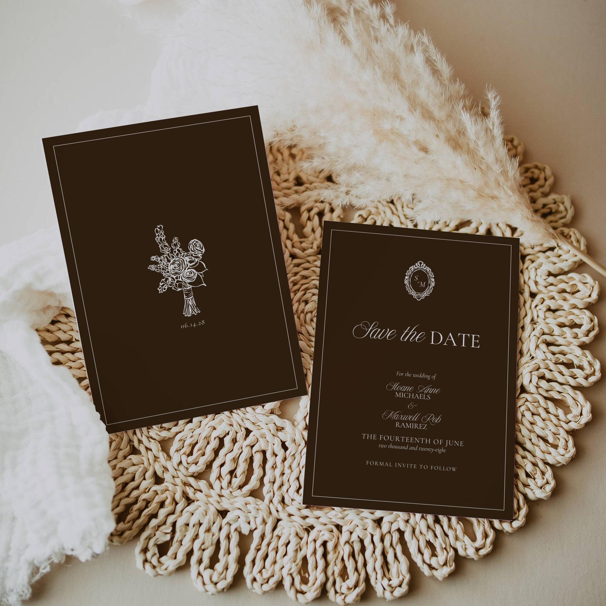 Two dark brown 'Save the Date' cards on a textured white surface