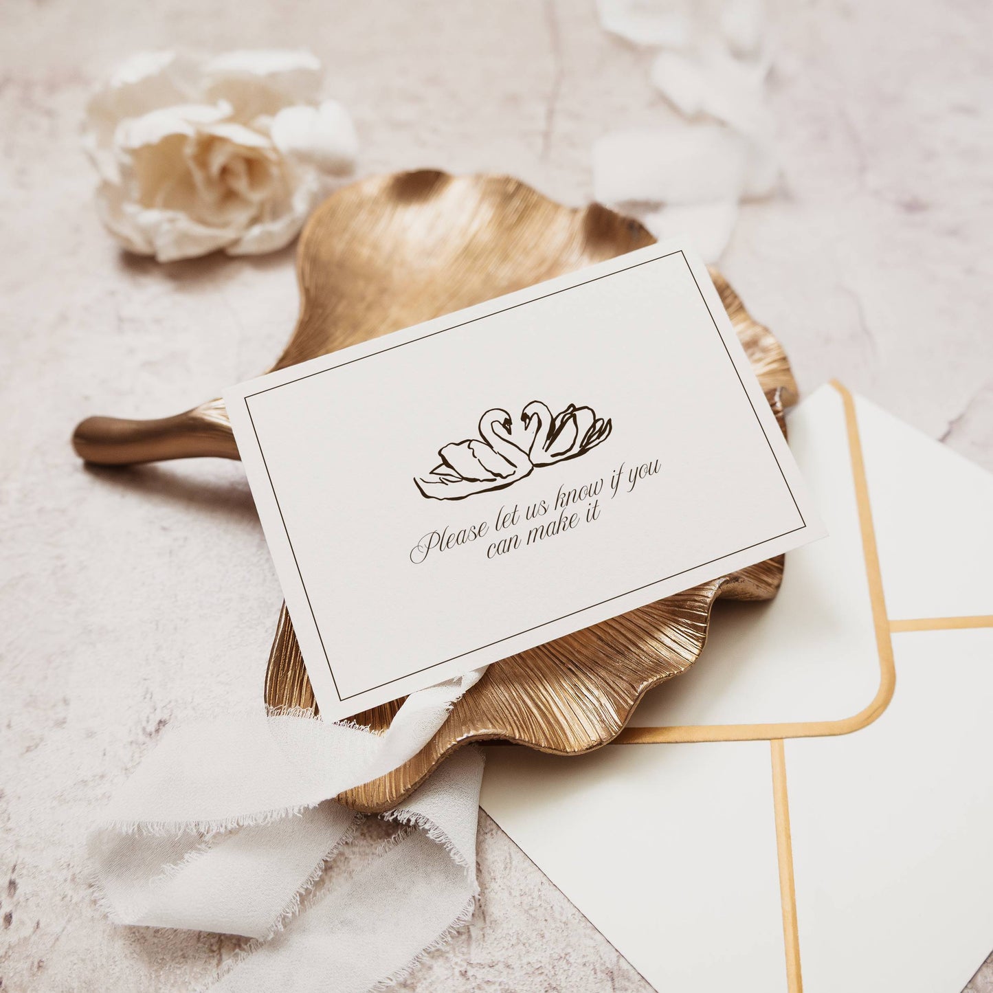 Card with swan design and envelope on textured surface