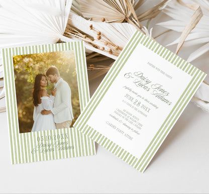 Wedding invitation card with couple photo and text on a white surface with dried leaves.