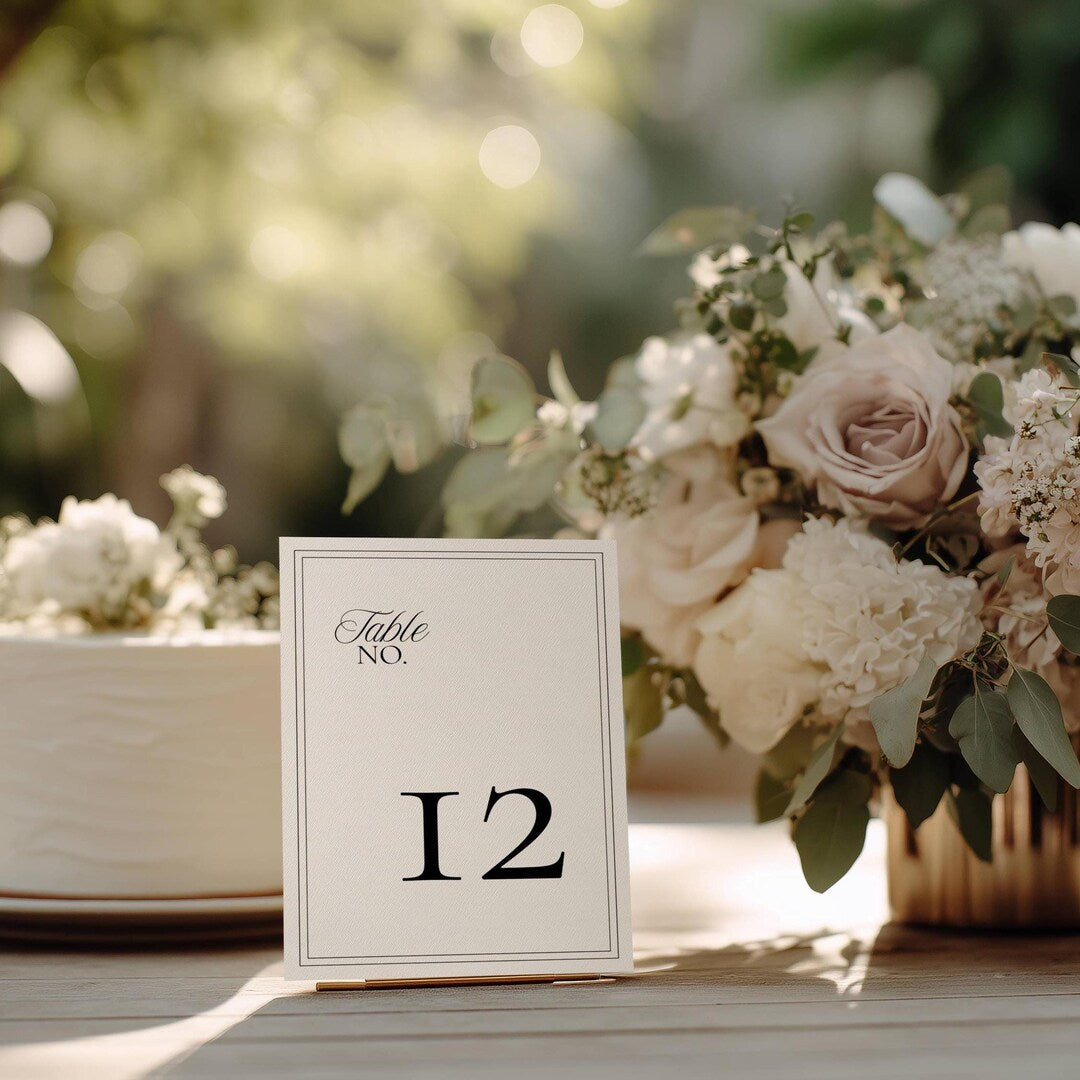 Minimalist wedding table number card with a black double-line border and the number 12 in bold serif type