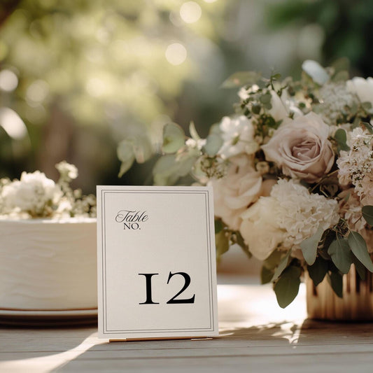 Minimalist wedding table number card with a black double-line border and the number 12 in bold serif type