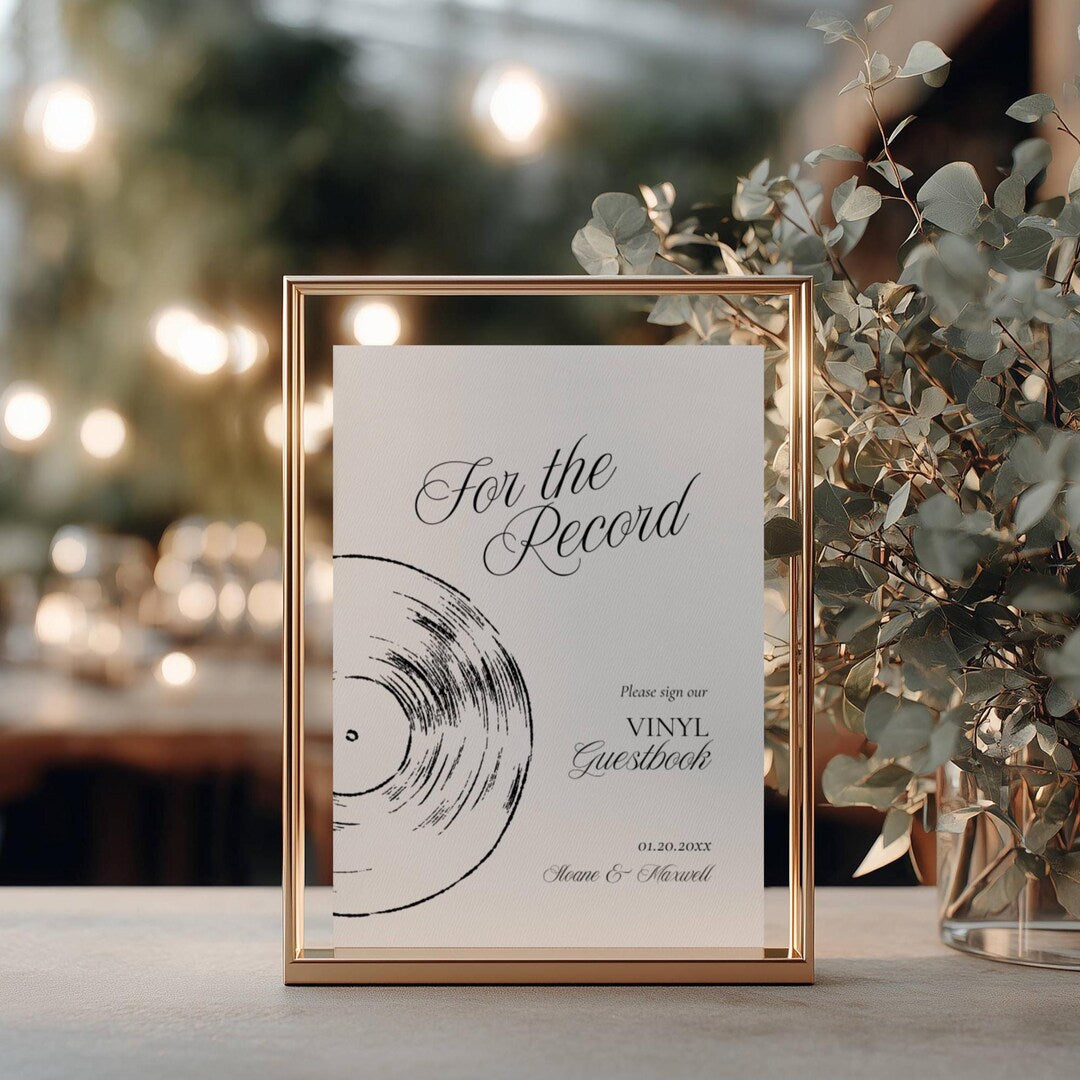 For the Record vinyl guestbook sign in a thin gold metal frame with a hand-drawn record illustration
