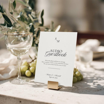 Old Money monogram audio guestbook sign on a gold metal stand with Pick up the phone and leave us a message script