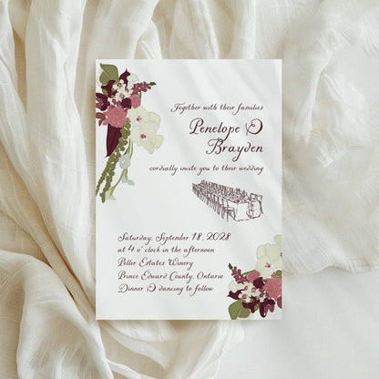 Burgundy floral wedding invitation with sample couple names and venue