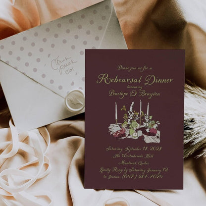 Burgundy floral rehearsal invitation paired with a wax-sealed envelope
