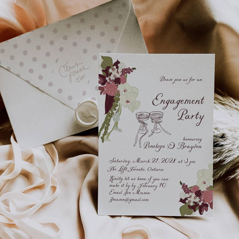 Plum floral engagement invitation paired with a polka dot envelope and wax seal
