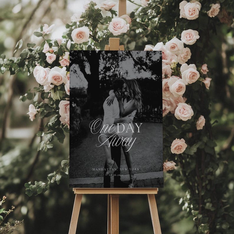 Black and white photo rehearsal welcome sign displayed on a wooden easel with white serif and script typography