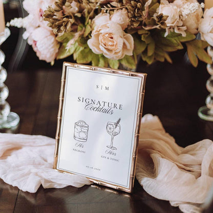 Old Money signature drinks sign in a gold frame styled with floral arrangements