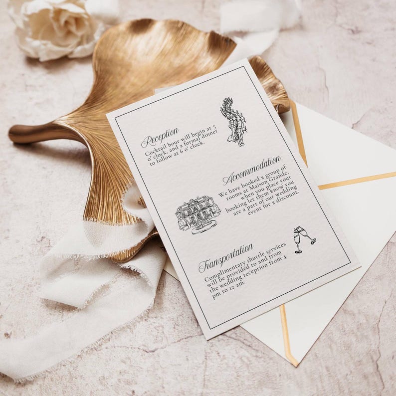 Black and white wedding invitation with reception and accommodation details on gold leaf dish