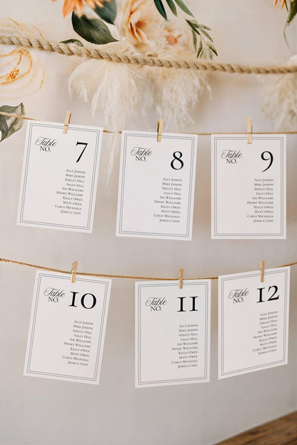 Seating chart cards hanging from twine string with wooden clothespins