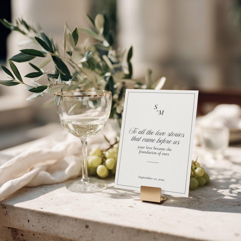 Love Stories Before Ours sign styled with wine glass and grapes on table setting