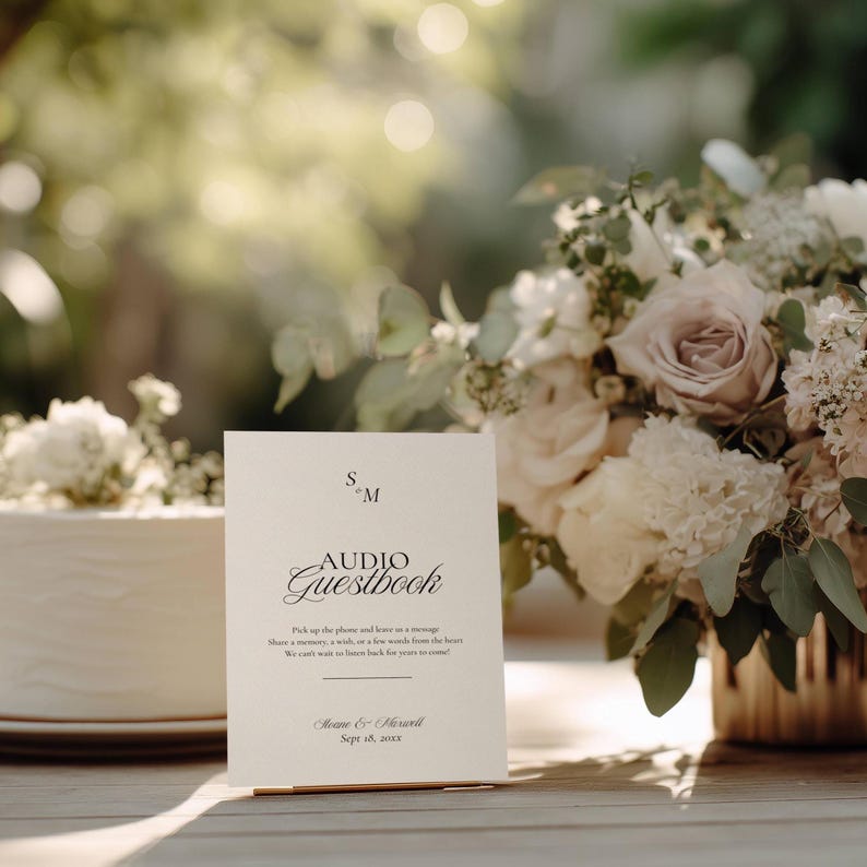 Old Money monogram audio guestbook sign styled beside a floral arrangement and wedding cake