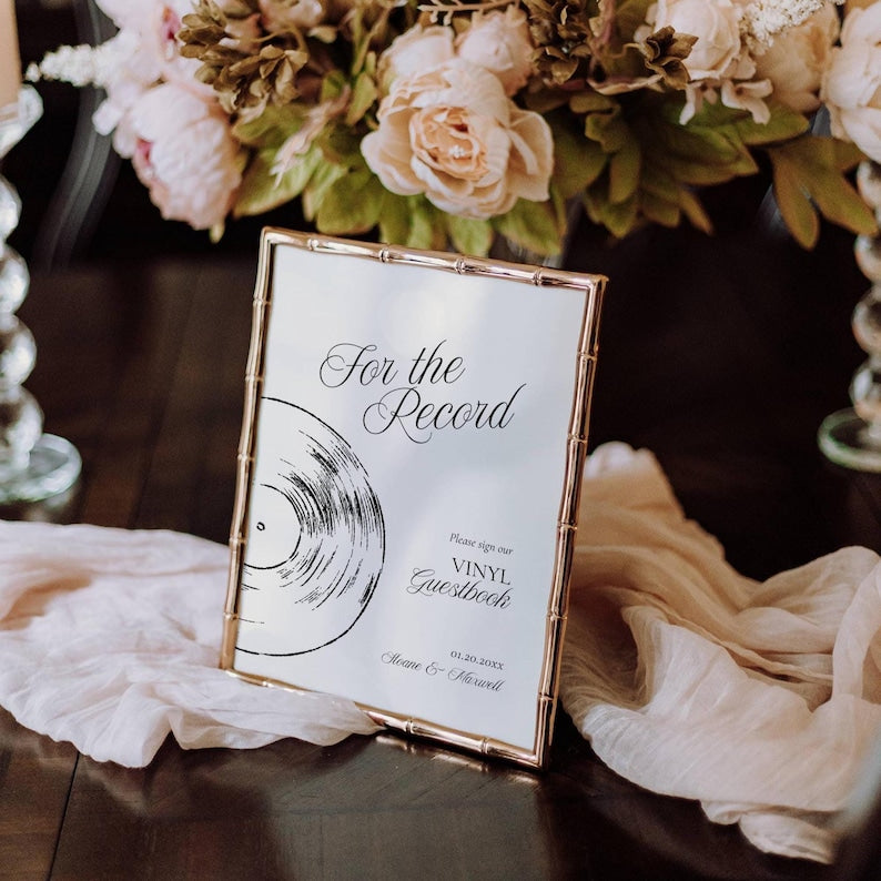 For the Record vinyl guestbook sign displayed in a gold bamboo-style frame