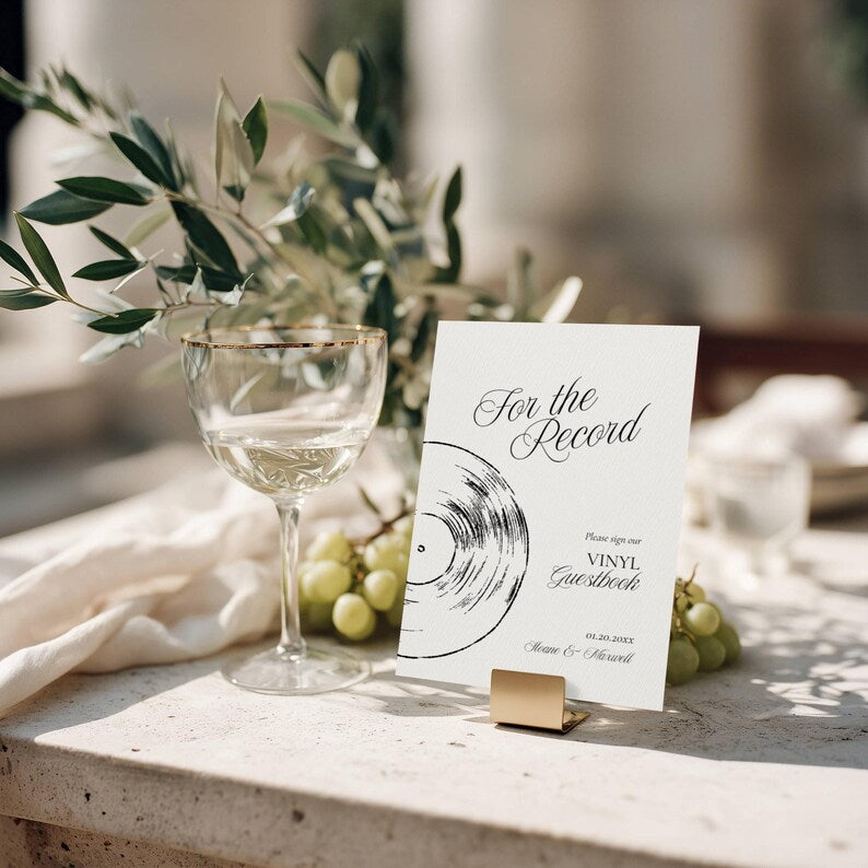 For the Record vinyl guestbook sign held upright by a small gold metal stand