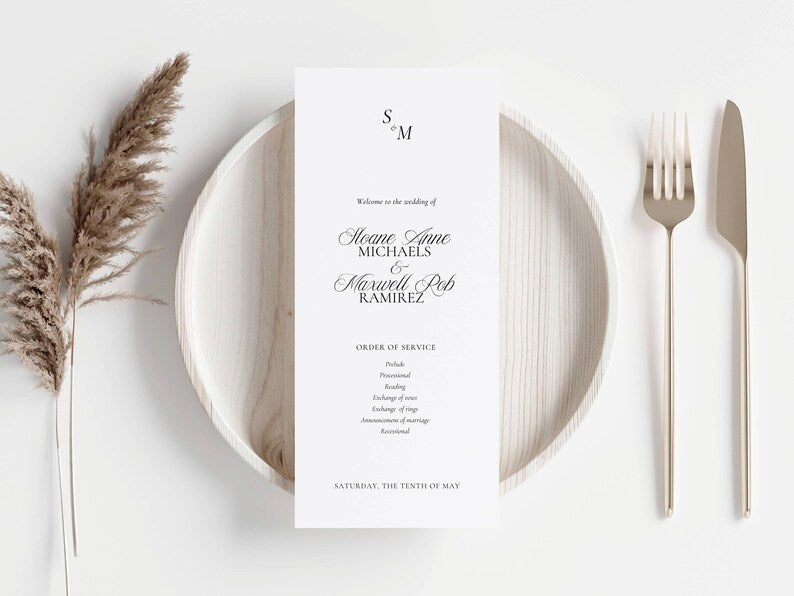 Wedding program card placed on a white dinner plate at a place setting