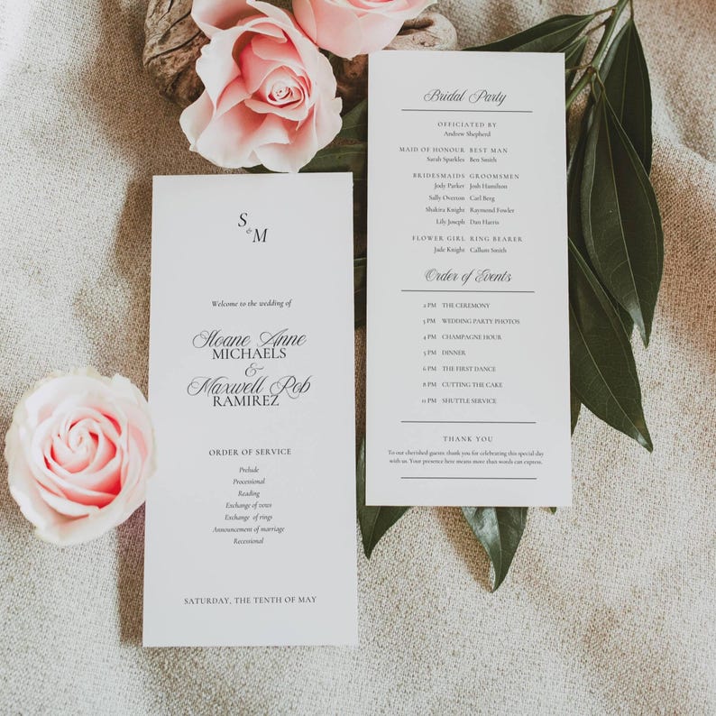 Old Money monogram wedding program styled with blush garden roses at a table setting