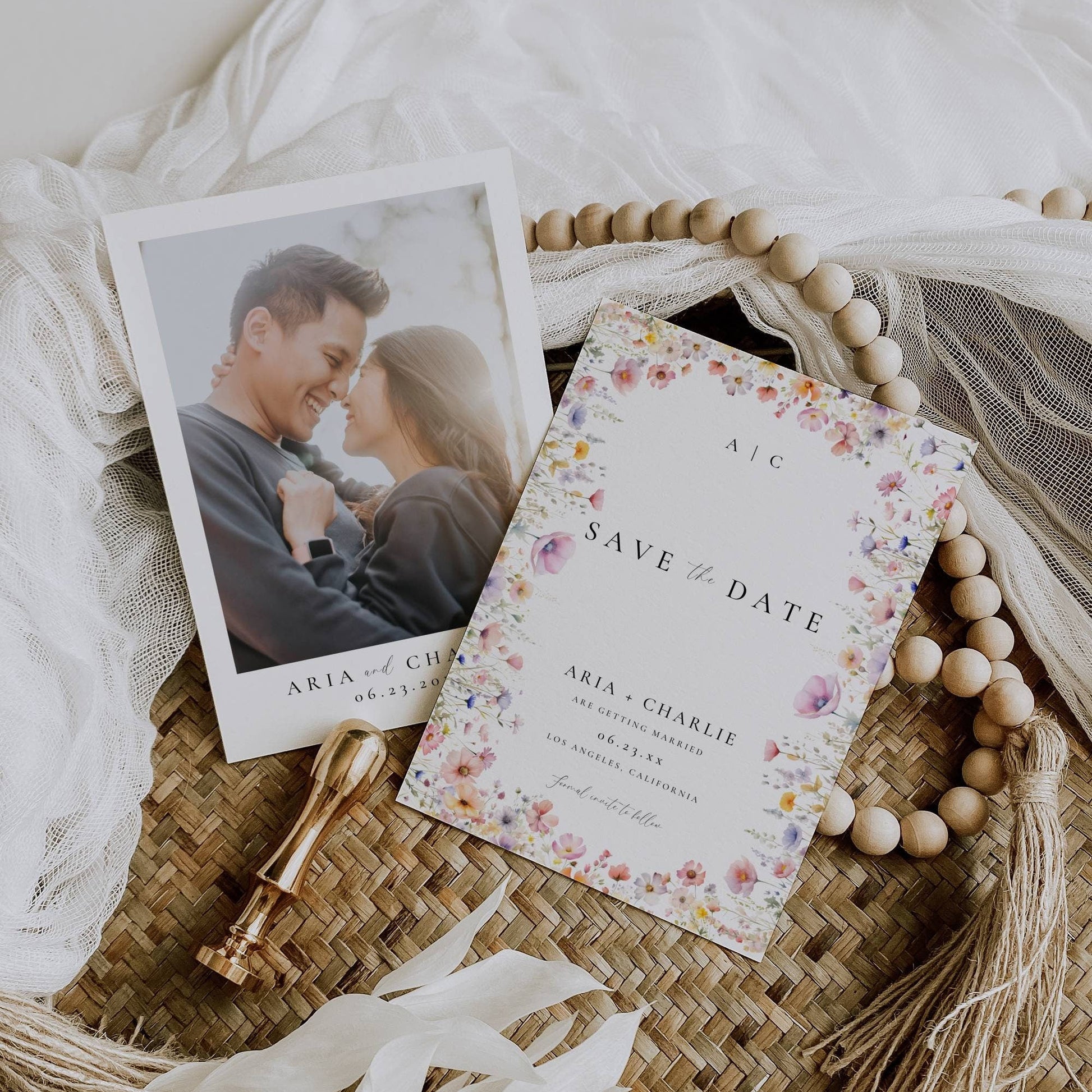 A wildflower wedding save the date with photo on a neutral elegant background with wood beads and elegant cloth
