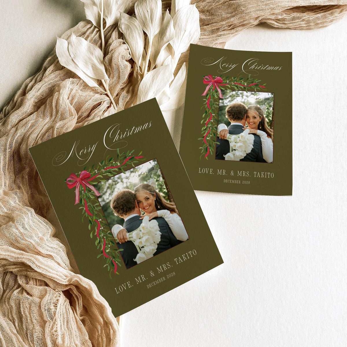 Olive green Mr and Mrs Christmas photo card template shown in two sizes with dried leaves and linen ribbon