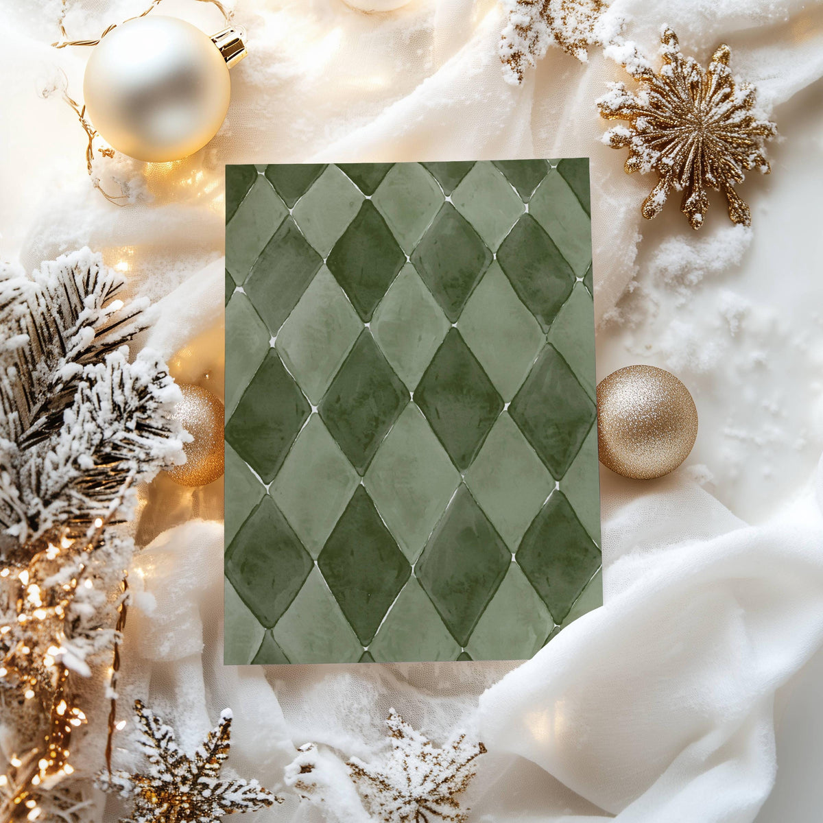 Green harlequin card back surrounded by gold snowflake ornaments and frosted branches