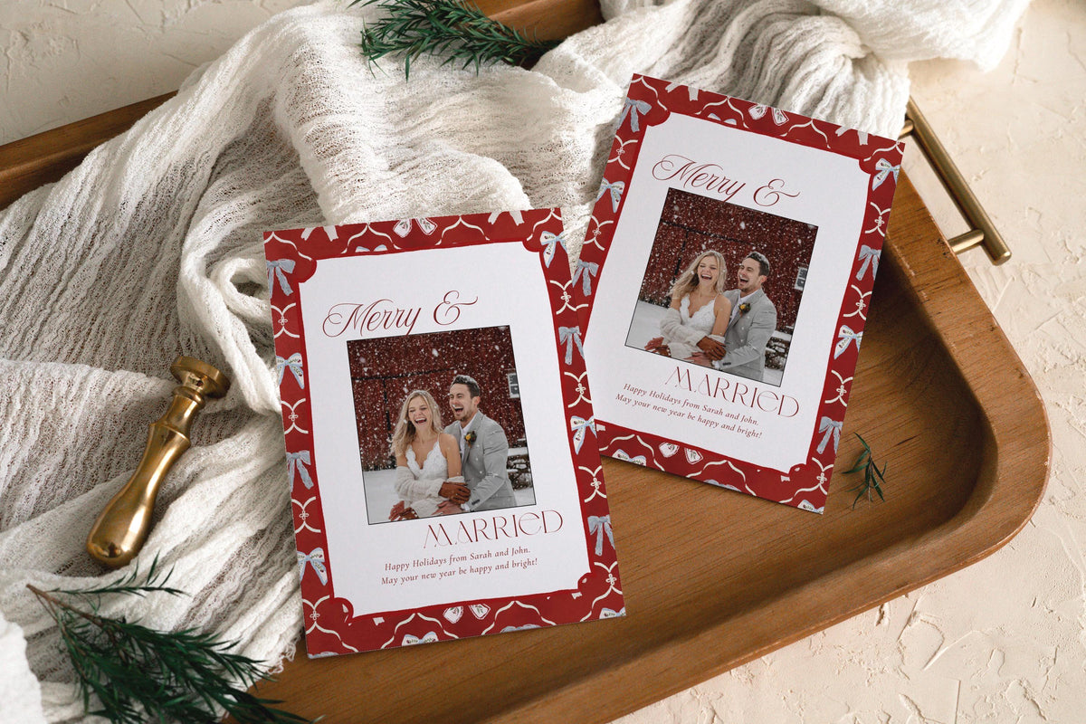 Close-up of the Merry and Married script and red bow border on the newlywed holiday photo card