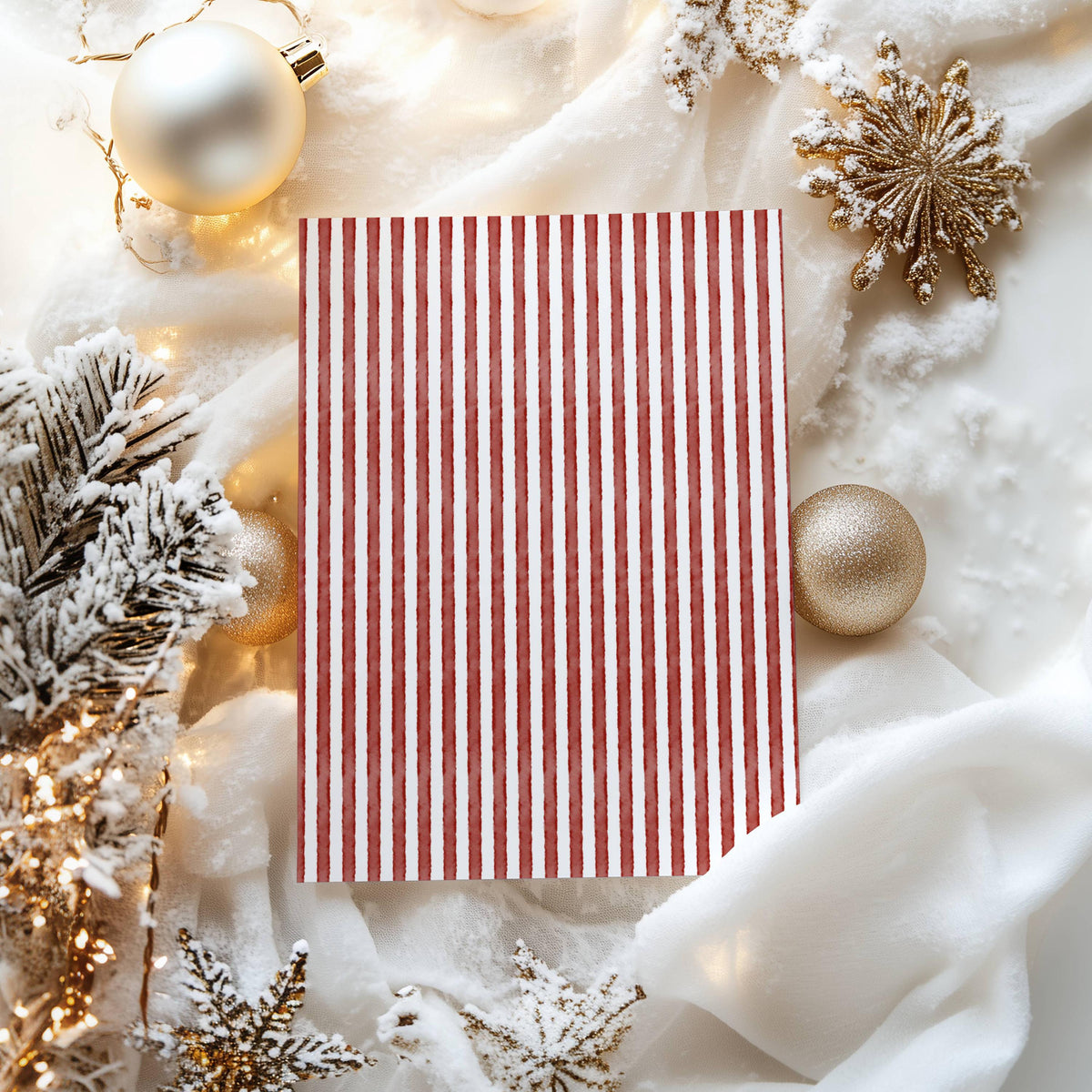 Hand-painted red and white stripe card back surrounded by gold ornaments and snowy fir branches